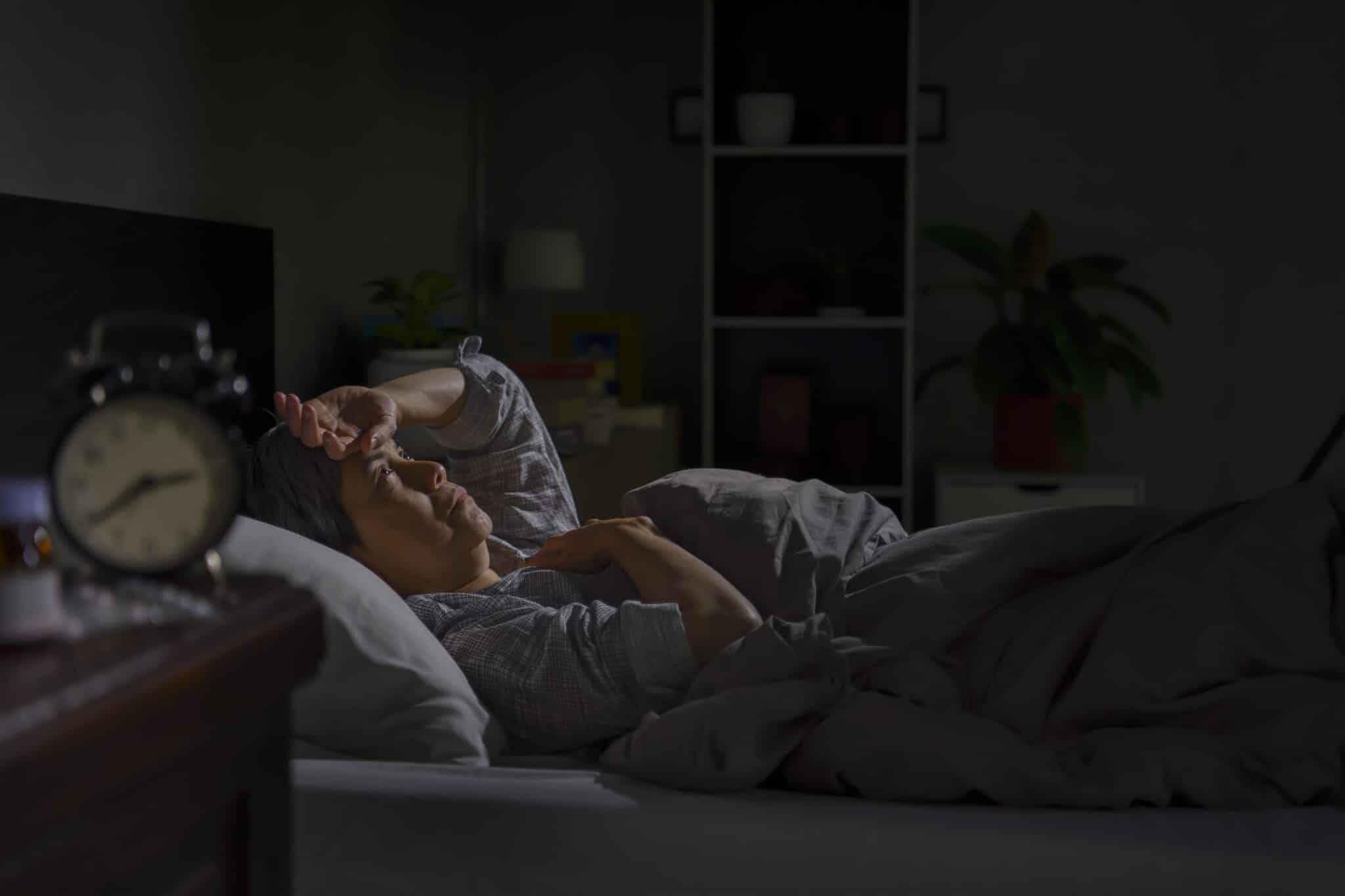 Patient struggling to sleep after surgery with proper positioning support demonstrating quality rest for faster healing