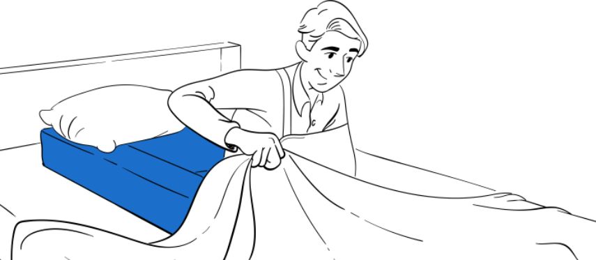 Post-shoulder surgery patient resting in own bed with Restore You Therapeutic Support positioning system and immobilization sling