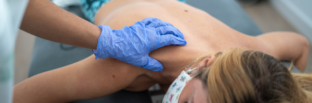 Physical therapist examining shoulder mobility - proper positioning during sleep after shoulder surgery aids recovery