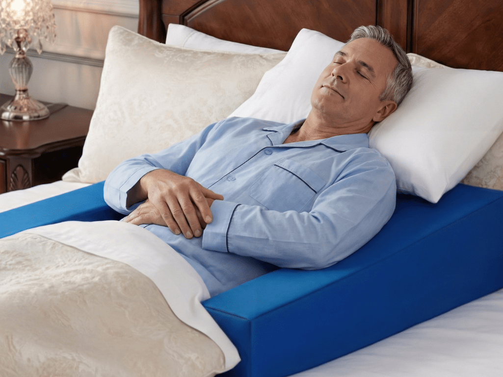 Man peacefully sleeping on Restore You pillow for bad shoulder in comfortable bed position with therapeutic support and pain relief