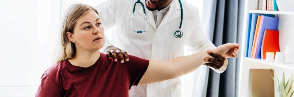 Patient consulting with doctor about how long to sleep normally after rotator cuff surgery during recovery appointment