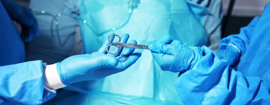 Surgical team during breast surgery procedure preparing for patient sleep after breast surgery recovery