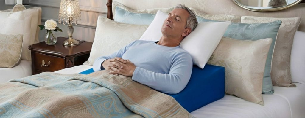 Patient demonstrating Maximally Loose Packed Position MLPP for shoulder surgery recovery using Restore You support pillow