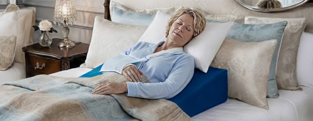 Woman peacefully sleeping demonstrating how to sleep after shoulder surgery with Restore You achieving comfortable 6-8 hour restorative sleep in own bed