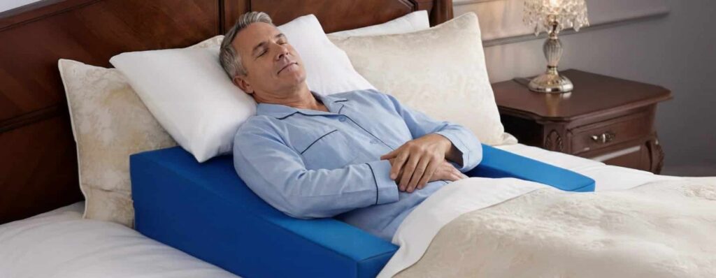 Patient demonstrating proper sleep after shoulder surgery positioning with Restore You therapeutic support system